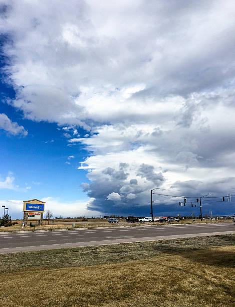 Falcon, Colorado, USA - March 2, 2016: A vertical shot captured with an iPhone6 of huge storm clouds over Falcon, Colorado, USA at 0900. The image shows the clouds from the intersection of Meridian Road and Woodman Road. There are vehicles traveling across Woodman Road.