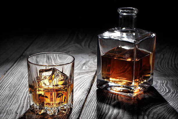 istock Backlit glass of whiskey with ice 513311390