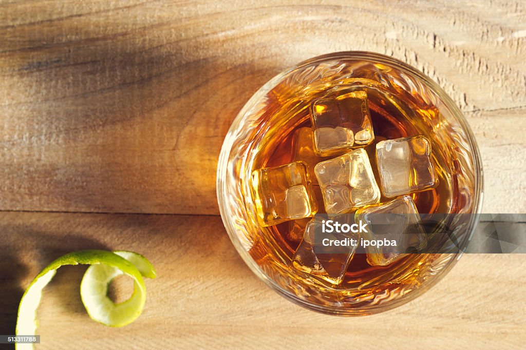 Glass of whiskey with ice on wooden background, Top view Drinking Glass Stock Photo