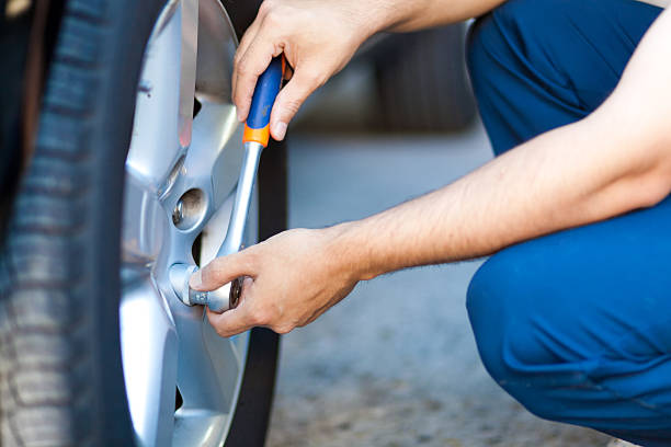 istock Auto mechanic in his workshop changing tires or rims 513313213