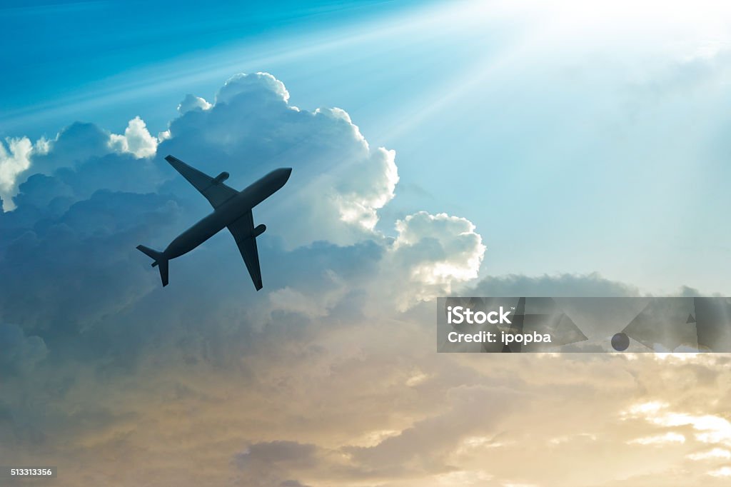 Airplane in the sky and cloud at sunrise Airplane Stock Photo