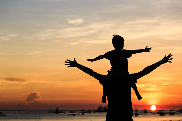 istock father and son on sunset beach 513314515
