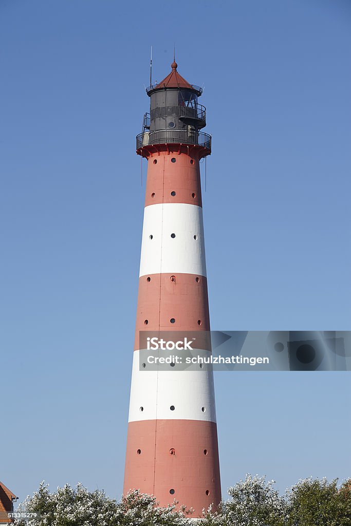 Westerhever (Germany) - Light house Landscape with salt meadows anad the light house Westerhever located near the coast of the North Sea taken on a sunny morning. This landscape is located near the coast of the North Sea (North Frisia, Germany, Schleswig Holstein): Blue Stock Photo