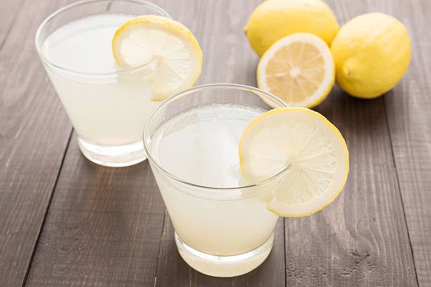 istock lemonade with fresh slice lemon on wooden table 513317482