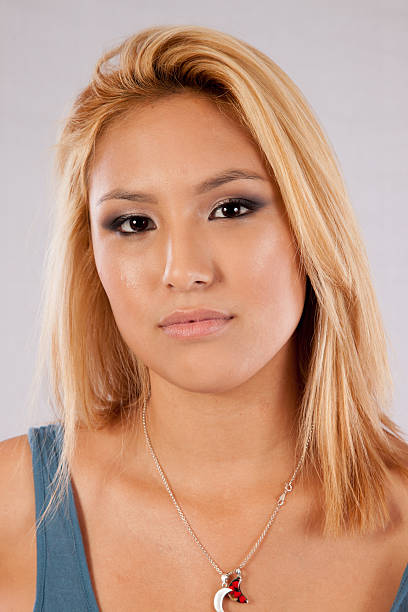 istock Blond woman in blue blouse looking thoughtful 513317859