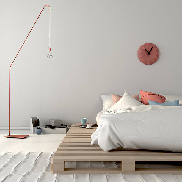 Stylish bed on wooden pallets and pink décor Stylish white bedroom with a bed on wooden pallets and pink décor carpet factory photos stock pictures, royalty-free photos & images