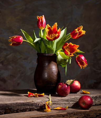 Still life with beautiful tulips and red apples