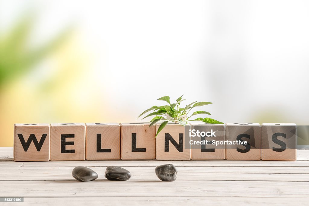 Wellness sign with wooden cubes Wellness sign with wooden cubes and flowers and stones Wellbeing Stock Photo