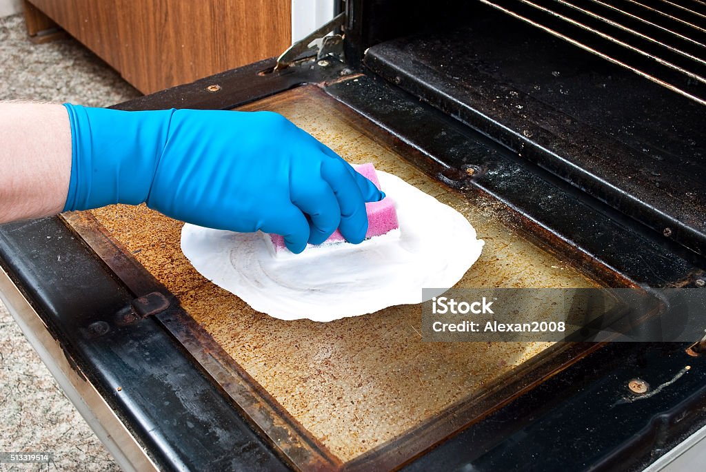 Cleaning kitchen oven Cleaning Stock Photo