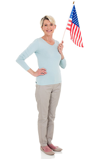 cheerful senior woman with american flag isolated on white