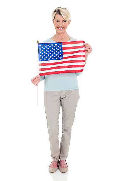 istock mid age woman with USA flag 513319984