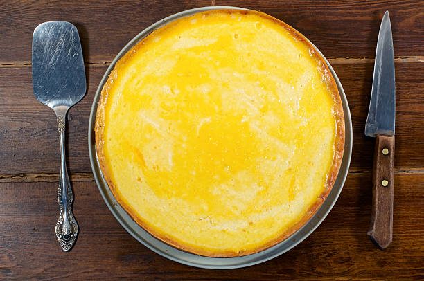 istock Round cheese cake top view with spatula and knife 513321108