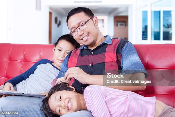 Young Father Spoiling His Children Stock Photo - Download Image Now - Adult, Asian and Indian Ethnicities, Boys