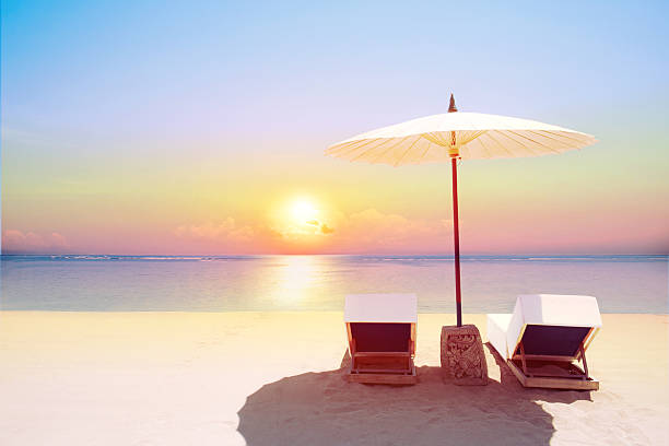 istock Tropical beach in sunset with beach chairs and umbrella 513324088