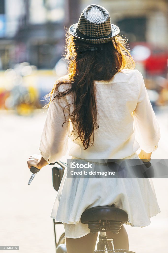 Woman cycling on the streets of Amsterdam. Adult Stock Photo