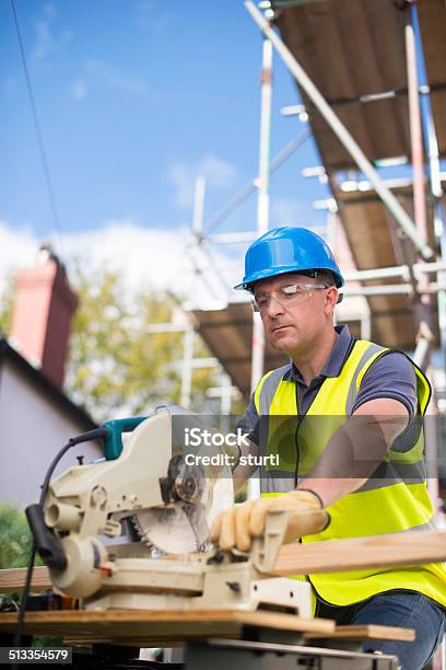 Carpenter Trimming His Wood Stock Photo - Download Image Now - Circular Saw, Construction Site, Protective Eyewear