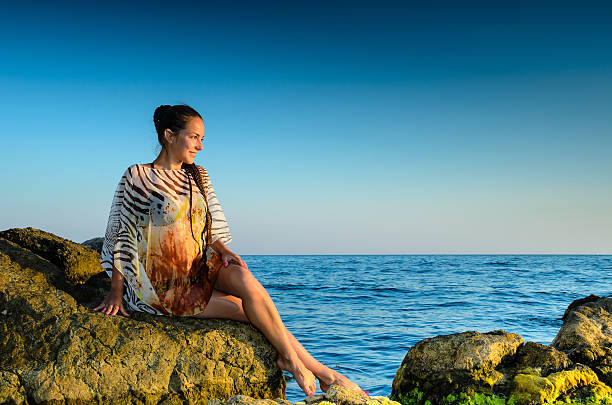 Young woman  on a rock stock photo