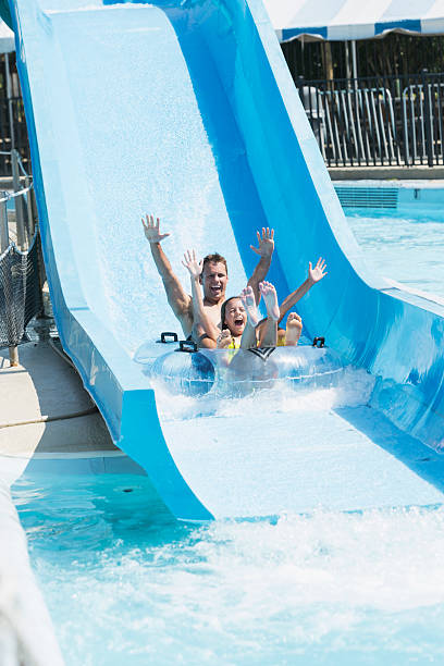 istock Father and daughter on water slide 513358411