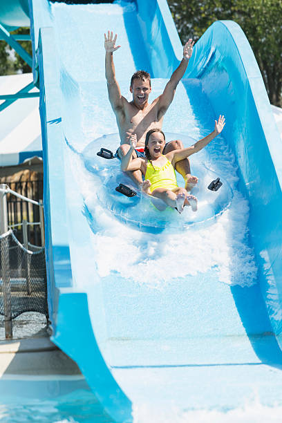 istock Father and daughter on water slide 513358947