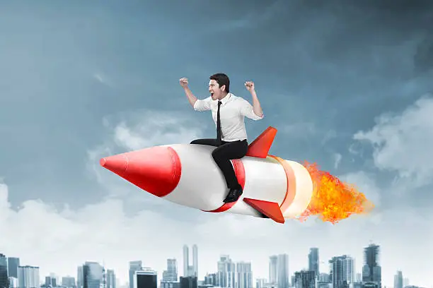 Photo of asian business man flying ride rocket