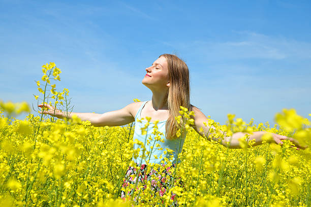 istock Young happy woman on blooming rapeseed field 513363790