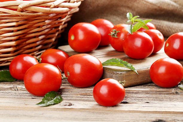 istock Fresh red tomatoes on wooden table 513364000
