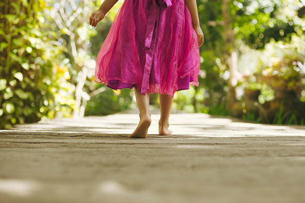 istock Girl walking in garden path 513364628