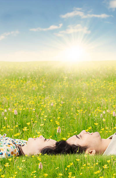 istock Couple lying down on the grass in springtime 513364972