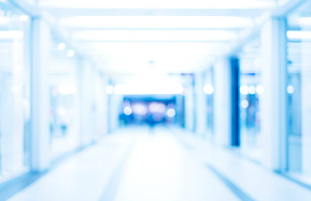 istock medical blurred background, empty hospital corridor in neon blue 513365526