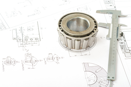 Roller bearing on blue prints with tool