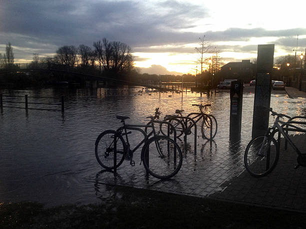 Flooded bicycles in the waters of a spring tide of the River Thames in Twickenham, UK. Shot with an iPhone.