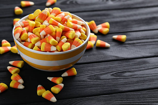 istock Halloween candy corns in bowl on black wooden background 513369070