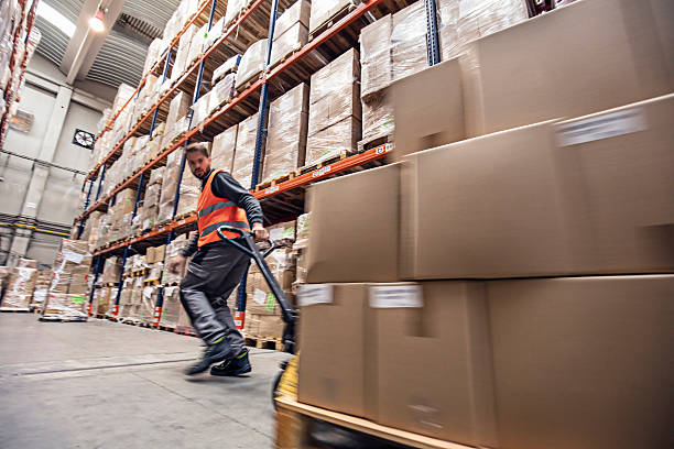Motion blur of a man moving boxes in a warehouse