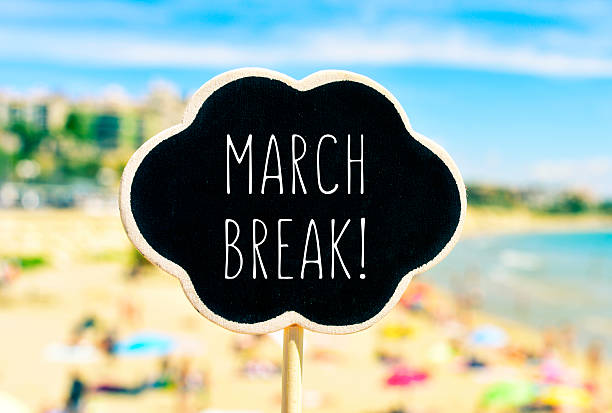 istock march break in a black signboard on the beach 513371274