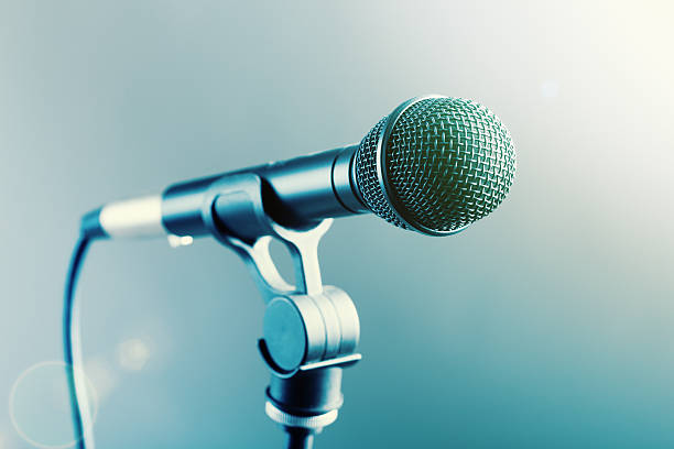 istock Close-up microphone on stand in smoky, spotlit surroundings 513372684