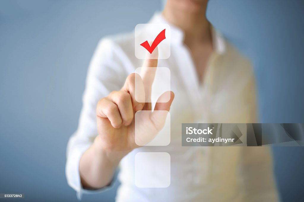 Check mark Businesswoman pushing button on touch screen. Questionnaire Stock Photo