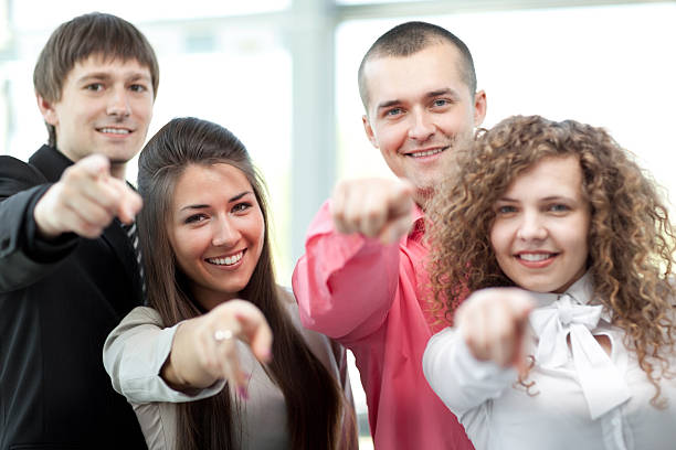 istock Happy diverse group of executives all pointing at you 513373520