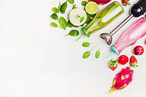 istock Green and red Smoothie bottles with ingredients and electric blender 513373650
