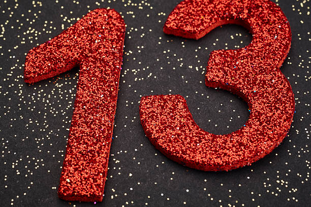 istock Number thirteen red color over a black background. Anniversary 513374002