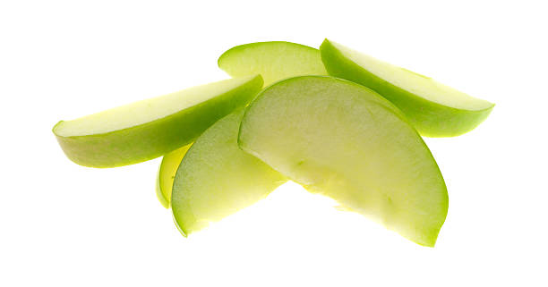 istock Green apple slices on white background 513374086