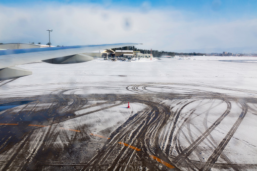 Airplane tire track on snow in runway, winter season