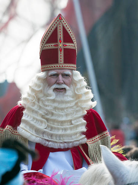 Saint Nicholas on his white horse Hoorn, the netherlands - november 16 ,2013 : Sinterklaas arrives in horn with his boat and horse. This is a Dutch children's party in December zwarte piet stock pictures, royalty-free photos & images