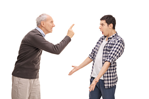 Studio shot of a senior father arguing with his adult son isolated on white background
