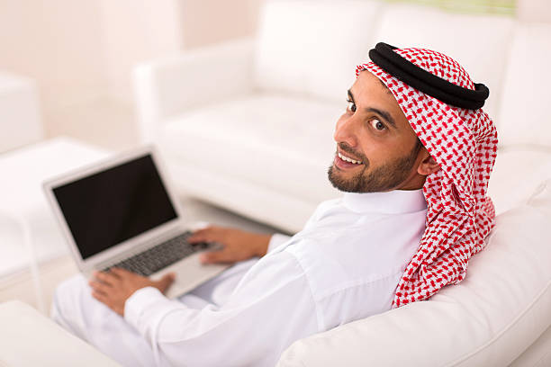 istock young arabian man with laptop 513377110