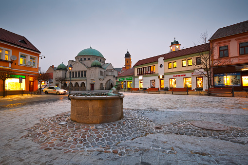 Trencin, Slovakia - January 20, 2016: Square in the old town of Trencin, Slovakia. Synagogue can be seen at the back. Town tower and old baroque church can be seen behind the buildings as well.