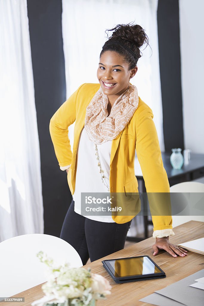 Stylish young woman working Stylish young woman working in office on digital tablet.  Mixed race African American / Caucasian. African Ethnicity Stock Photo