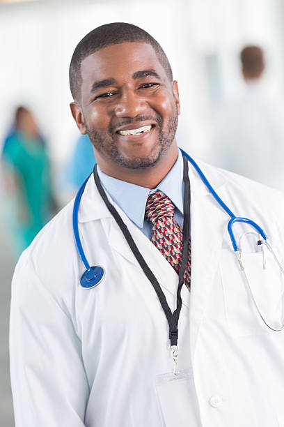 istock Smiling doctor in lab coat and tie with stethoscope 513379685
