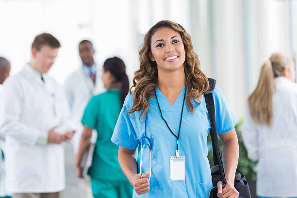 istock Confident Hispanic nurse walking in busy hospital hallway during shift 513380063