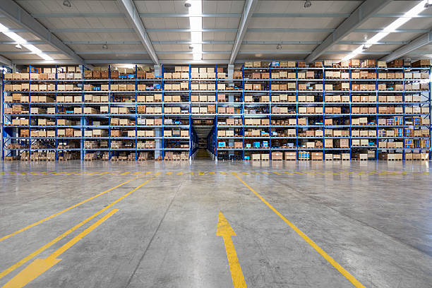 many shelves of cardboard boxes in storehouse - warehouse stok fotoğraflar ve resimler