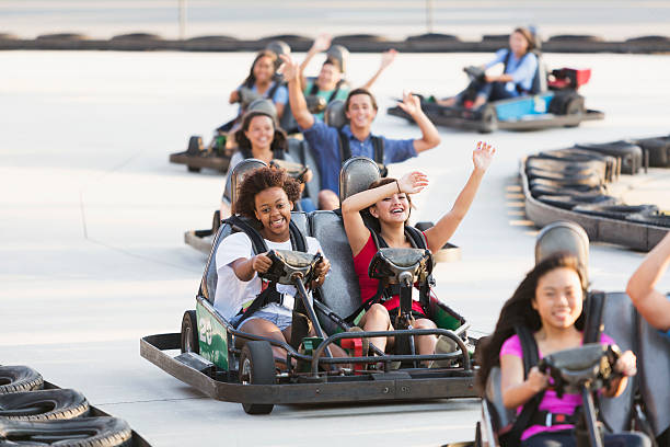 istock Group of teens riding go carts 513380969